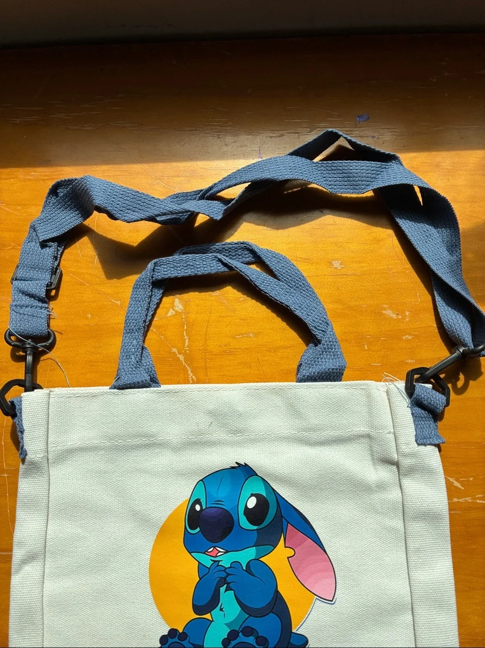Stitch Canvas Tote in Cream with Blue Stitch Graphic. It’s a Crossbody bag too